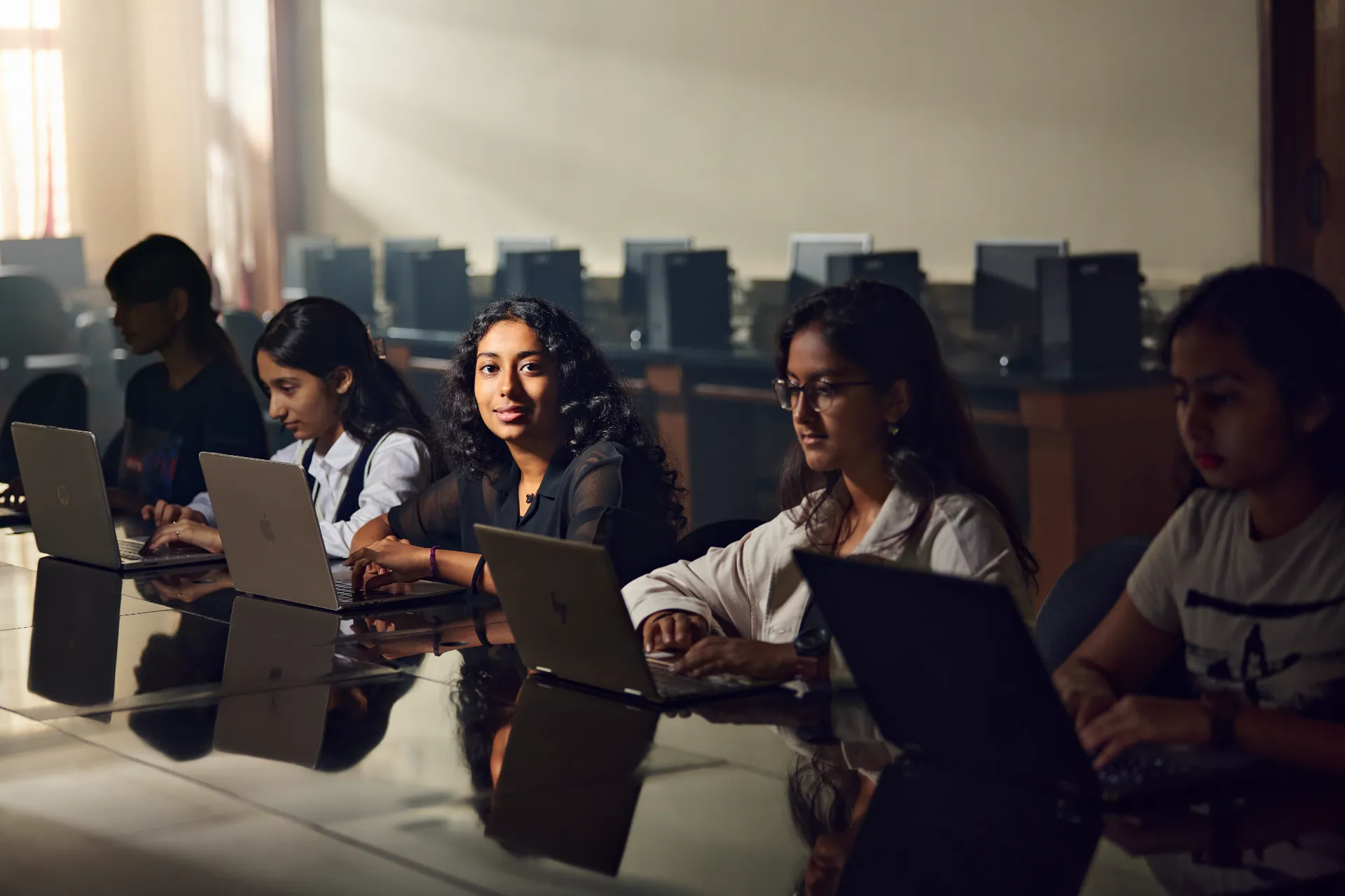 Students studying on laptops at JAIN Public School
