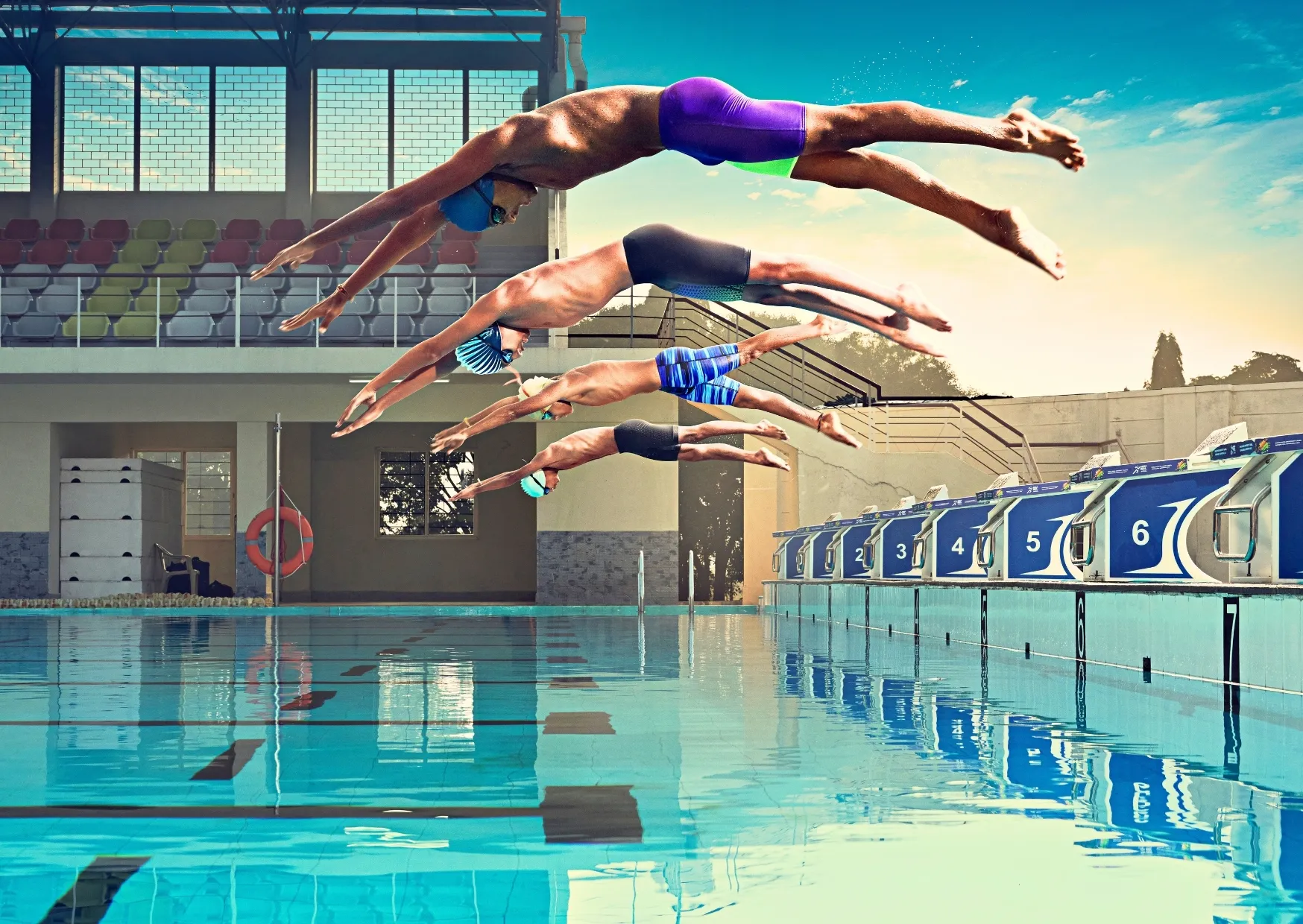 Swimmers diving off the blocks
